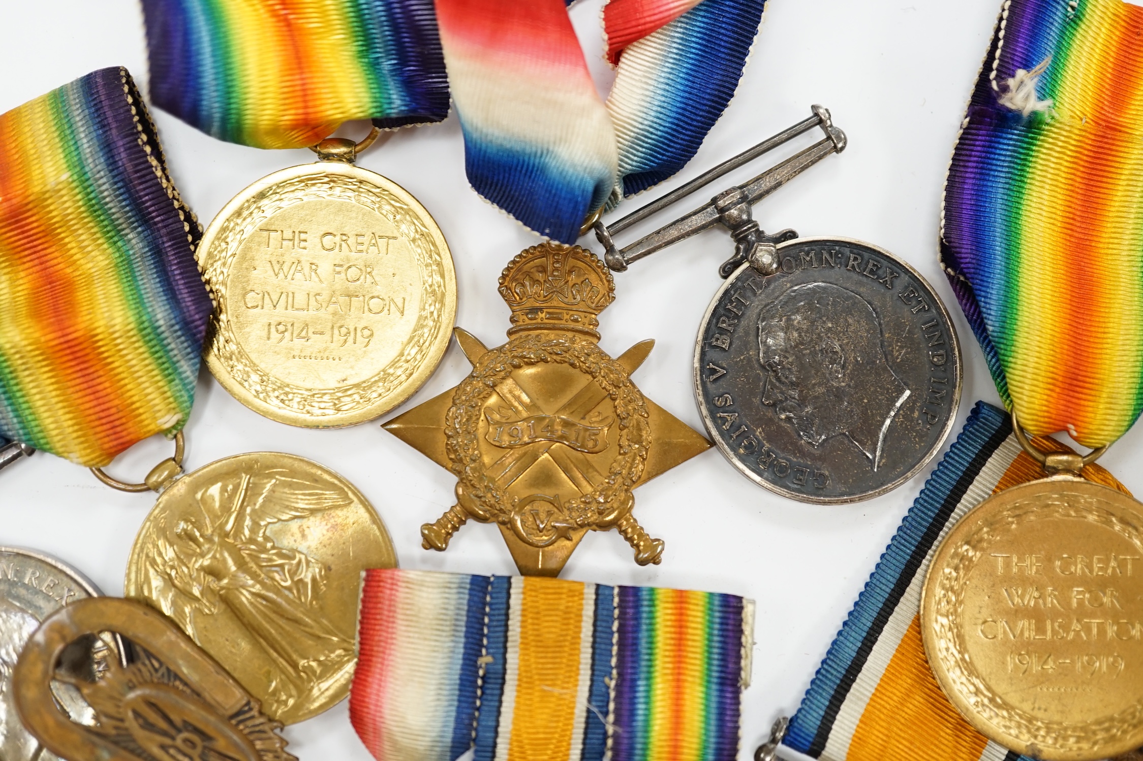 Three First World War medal trios awarded to; Pte. W.C. Belfrage 3rd Canadian MTD Rifles, Cpl. R.W. Wells R.F.A. and Pte. F.G. Walker R.A.M.C. together with two additional British war medals, two miniature metal groups,